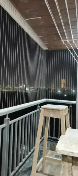 Invisible grill installation on balcony with night city view in Chennai apartment